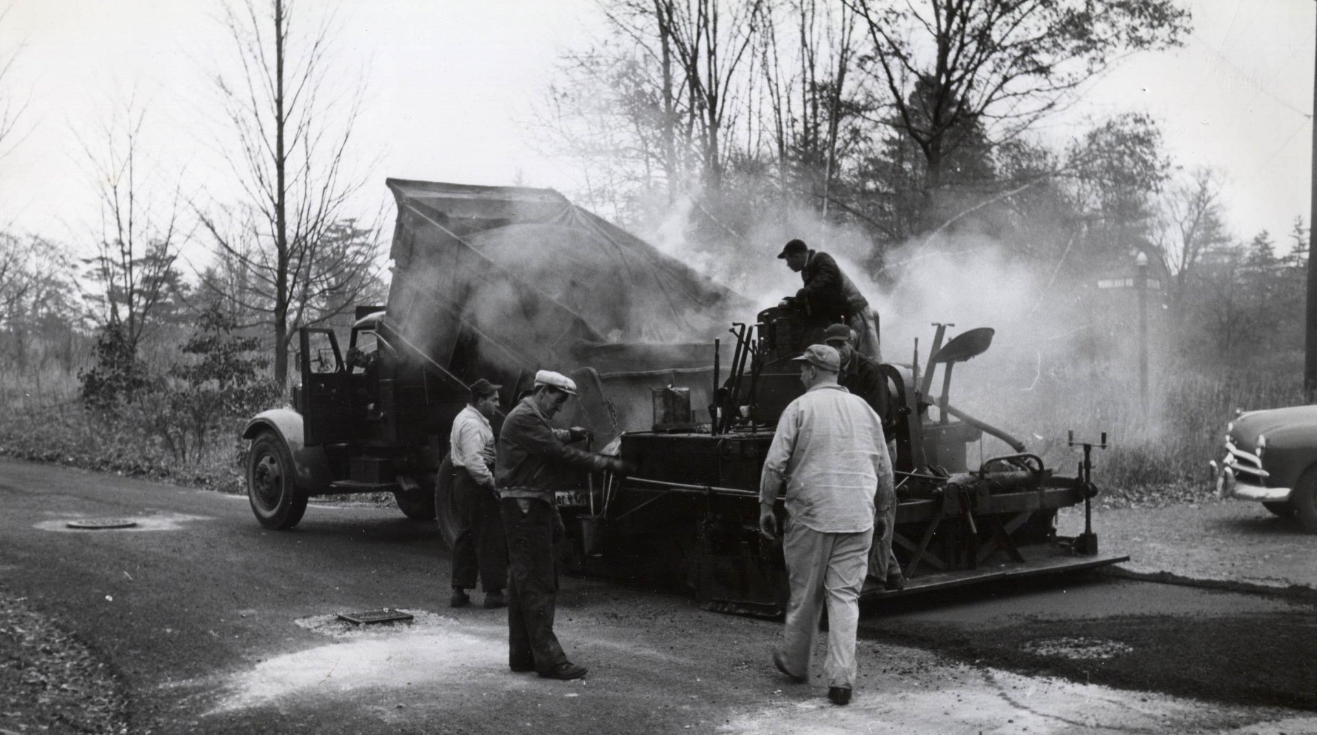 historical photo of McCourt workers laying asphalt